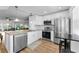 Well-lit kitchen with stainless steel appliances, granite countertops, and white cabinetry at 952 Virginia St # 303, Dunedin, FL 34698