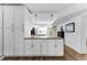 Kitchen island featuring granite countertops, white cabinets, and wood-look floors at 952 Virginia St # 303, Dunedin, FL 34698