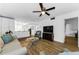 Cozy living room with wood-look floors flowing into the kitchen and dining areas at 952 Virginia St # 303, Dunedin, FL 34698