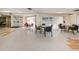 Well-lit meeting room featuring tables, chairs, and a view of the outdoor pool at 952 Virginia St # 303, Dunedin, FL 34698