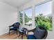 Cozy sunroom featuring large windows with treetop views and comfortable seating at 952 Virginia St # 303, Dunedin, FL 34698