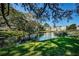 Scenic pond view showcasing well-maintained landscaping and building exteriors in a tranquil community setting at 952 Virginia St # 303, Dunedin, FL 34698