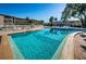 Expansive pool with lounging area, complemented by lush landscaping at 952 Virginia St # 303, Dunedin, FL 34698