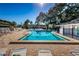 Beautiful community pool with lounge chairs and well maintained grounds at 952 Virginia St # 303, Dunedin, FL 34698