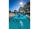 Resort-style swimming pool with lounge chairs and well maintained grounds at 952 Virginia St # 303, Dunedin, FL 34698