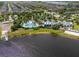 Aerial view of a resort-style community pool, clubhouse, and lake at 11038 Spring Point Cir, Riverview, FL 33579