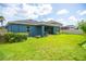 A backyard with a blue house and a covered patio at 11038 Spring Point Cir, Riverview, FL 33579