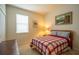 A cozy bedroom with a wood frame bed and a window with blinds at 11038 Spring Point Cir, Riverview, FL 33579