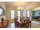 Traditional dining room with wooden table, chandelier, and decorative artwork on the walls at 11038 Spring Point Cir, Riverview, FL 33579