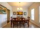 Traditional dining room with wooden table, chandelier, and decorative artwork on the walls at 11038 Spring Point Cir, Riverview, FL 33579