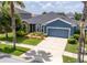Charming blue single-story home with well-maintained landscaping and a spacious two-car garage at 11038 Spring Point Cir, Riverview, FL 33579
