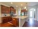 Open kitchen with granite countertops, stainless steel appliances, and center island with wood floors at 11038 Spring Point Cir, Riverview, FL 33579