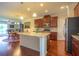Open kitchen with granite countertops, stainless steel appliances, and center island with wood floors at 11038 Spring Point Cir, Riverview, FL 33579