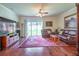 Comfortable living room area with hardwood floors, leather furniture, and sliding glass doors at 11038 Spring Point Cir, Riverview, FL 33579