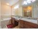 A spacious main bathroom with a dual sink vanity, granite countertops and a glass enclosed shower at 11038 Spring Point Cir, Riverview, FL 33579