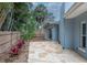 Backyard featuring a stone paver patio, privacy fence, and lush landscaping at 111 Carlyle Dr, Palm Harbor, FL 34683