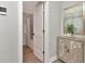 Bathroom entry showcasing the cabinet and view of the bath/shower at 111 Carlyle Dr, Palm Harbor, FL 34683