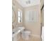 Bright bathroom featuring a pedestal sink, mirrored medicine cabinet, and glass-enclosed shower at 111 Carlyle Dr, Palm Harbor, FL 34683