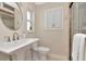Well-lit bathroom with vanity sink, mirror, and a glass-enclosed shower at 111 Carlyle Dr, Palm Harbor, FL 34683