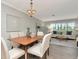 Bright dining room featuring a table with seating, chandelier lighting, and open to living space at 111 Carlyle Dr, Palm Harbor, FL 34683