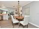Cozy dining area with a chandelier and an open view to the living room and kitchen at 111 Carlyle Dr, Palm Harbor, FL 34683