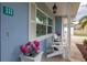 Welcoming porch with seating and flower pots at 111 Carlyle Dr, Palm Harbor, FL 34683