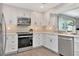 Well-lit kitchen with stainless steel appliances, wood floors, and shaker cabinets at 111 Carlyle Dr, Palm Harbor, FL 34683