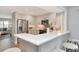 A bright, modern kitchen features stainless steel appliances, sleek countertops, and barstool seating at 111 Carlyle Dr, Palm Harbor, FL 34683