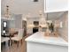 A modern kitchen with a stylish chandelier, stainless steel appliances, and light grey cabinets at 111 Carlyle Dr, Palm Harbor, FL 34683