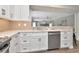 A bright kitchen with stainless steel appliances, modern white cabinets, and lots of countertop space at 111 Carlyle Dr, Palm Harbor, FL 34683