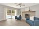 Bright living room with stone fireplace and sliding doors to the pool area at 111 Carlyle Dr, Palm Harbor, FL 34683