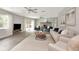 Open-concept living area with ceiling fans, fireplace, and view of backyard at 111 Carlyle Dr, Palm Harbor, FL 34683
