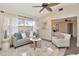 Bright living room with a large window and stylish furnishings including gray sofa and accent chair at 111 Carlyle Dr, Palm Harbor, FL 34683