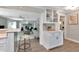 Bright open-concept living room with a fireplace, wood floors, and bar seating area perfect for entertaining at 111 Carlyle Dr, Palm Harbor, FL 34683