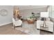 Bright living room with hardwood floors, stylish furniture, and open layout to the dining area at 111 Carlyle Dr, Palm Harbor, FL 34683