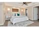 Inviting main bedroom with lamps, ceiling fan, and view of ensuite bathroom at 111 Carlyle Dr, Palm Harbor, FL 34683