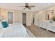 Bright main bedroom with ensuite bathroom, dresser, wood-look flooring at 111 Carlyle Dr, Palm Harbor, FL 34683