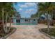 Backyard oasis featuring a private pool surrounded by a stone paver patio and lush landscaping at 111 Carlyle Dr, Palm Harbor, FL 34683