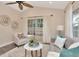 Comfortable sitting area with natural light, ceiling fan, and modern décor at 111 Carlyle Dr, Palm Harbor, FL 34683