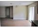 Bright dining area with laminate floors, sliding glass doors, neutral paint, and a modern chandelier at 12615 Logan Pl, Tampa, FL 33625