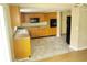 Functional kitchen featuring wood cabinets, laminate countertops, tile floors, and modern appliances at 12615 Logan Pl, Tampa, FL 33625