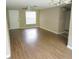 Spacious living room featuring hardwood floors, neutral paint, a ceiling fan, and a bright window at 12615 Logan Pl, Tampa, FL 33625