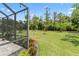 Expansive backyard featuring well-maintained lawn and lush trees, perfect for outdoor activities at 137 Silver Falls Dr, Apollo Beach, FL 33572