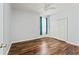 Bright bedroom with wood-look floors, a ceiling fan and a closet with folding doors at 137 Silver Falls Dr, Apollo Beach, FL 33572