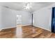 Bright bedroom with wood floors, neutral paint, and a ceiling fan at 137 Silver Falls Dr, Apollo Beach, FL 33572
