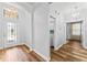 Welcoming hallway featuring hardwood floors, an ornate chandelier, and ample natural light at 137 Silver Falls Dr, Apollo Beach, FL 33572
