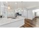Open-concept kitchen with a quartz island, stainless steel appliances, and modern pendant lighting at 137 Silver Falls Dr, Apollo Beach, FL 33572