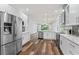 Bright, updated kitchen with a stainless steel refrigerator and open layout at 137 Silver Falls Dr, Apollo Beach, FL 33572