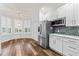 Well-lit kitchen featuring stainless steel appliances, white cabinetry, and a cozy dining area at 137 Silver Falls Dr, Apollo Beach, FL 33572