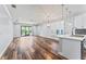 Spacious living room featuring hardwood floors, recessed lighting, and modern pendant lights at 137 Silver Falls Dr, Apollo Beach, FL 33572